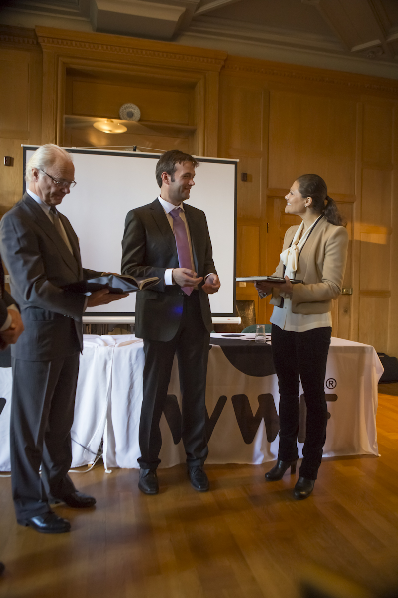 H. M. King Carl XVI Gustaf looking at my book while I am talking to the Crown Princess Victoria of Sweden.